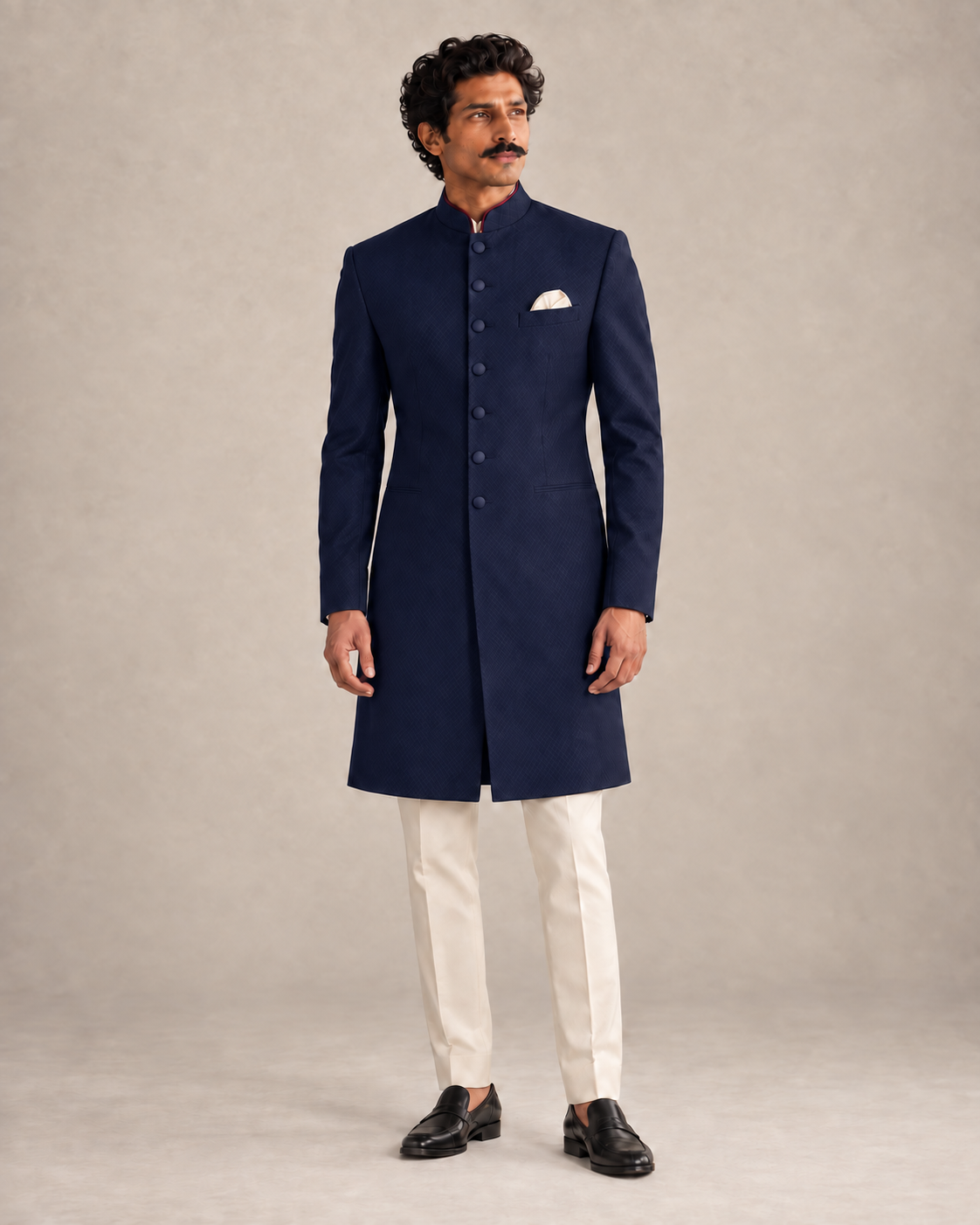 The Marwar midnight-blue achkan with seven tonal buttons, worn with ivory trousers