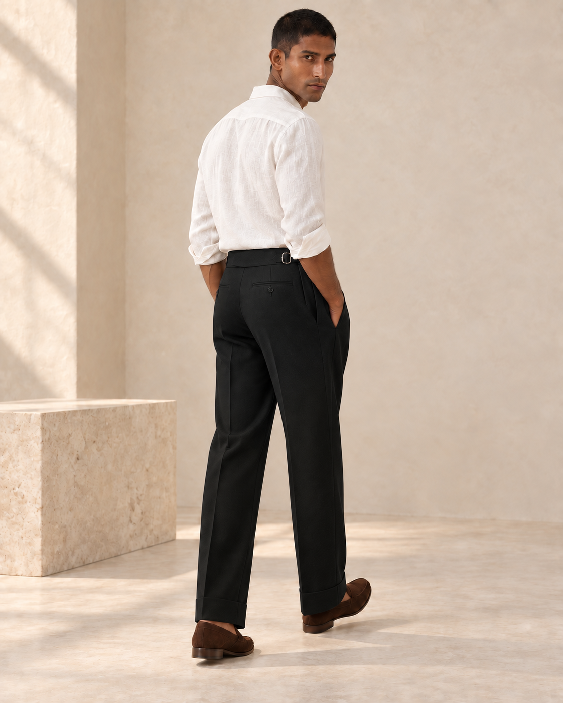 SALVE The Cadogan double-pleated trousers in black, rear three-quarter view