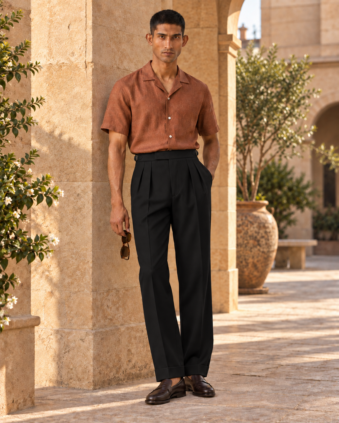 SALVE The Cadogan double-pleated trousers in black, worn in daylight