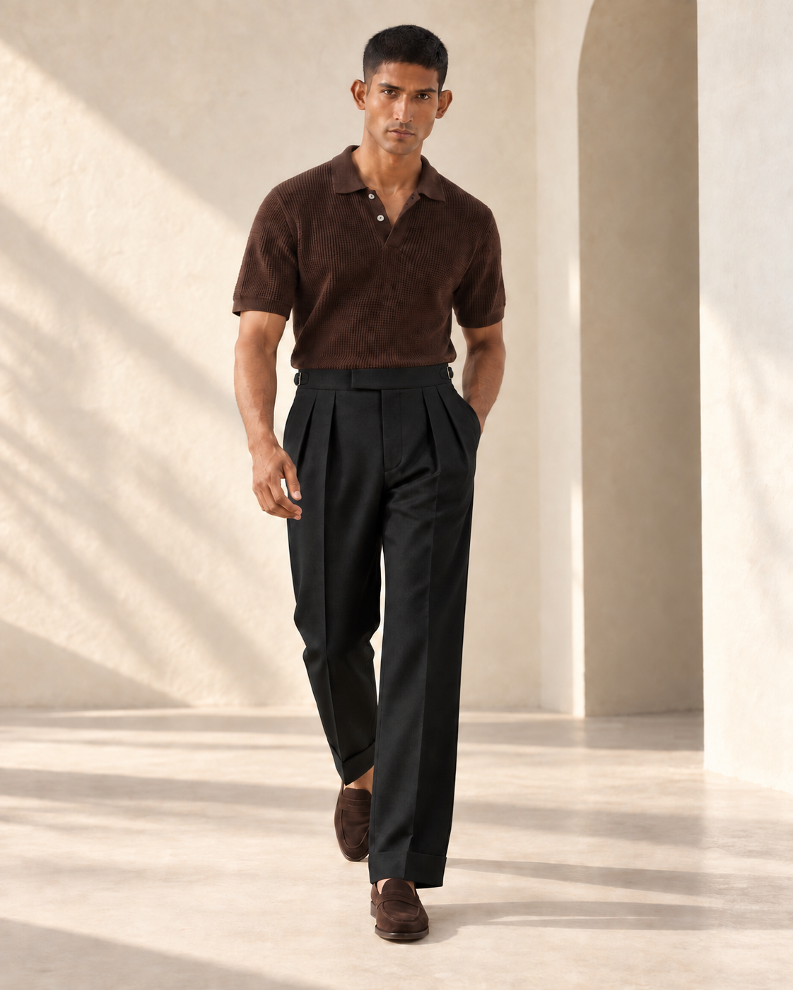 SALVE The Cadogan double-pleated trousers in black, shown walking