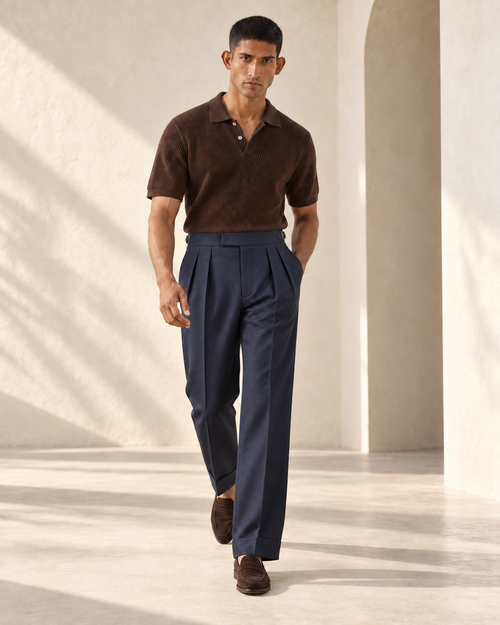 SALVE The Cadogan double-pleated trousers in navy, shown walking