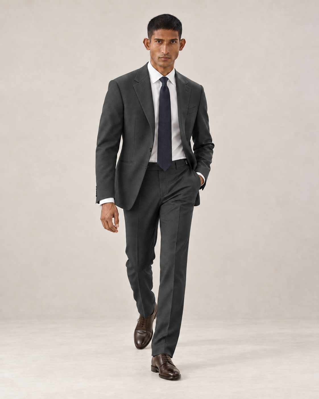 SALVE The Lutyens two-piece suit in charcoal-grey, shown walking
